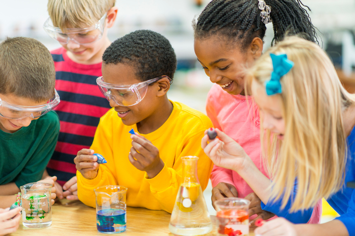 Elementary school students working on science experiments.